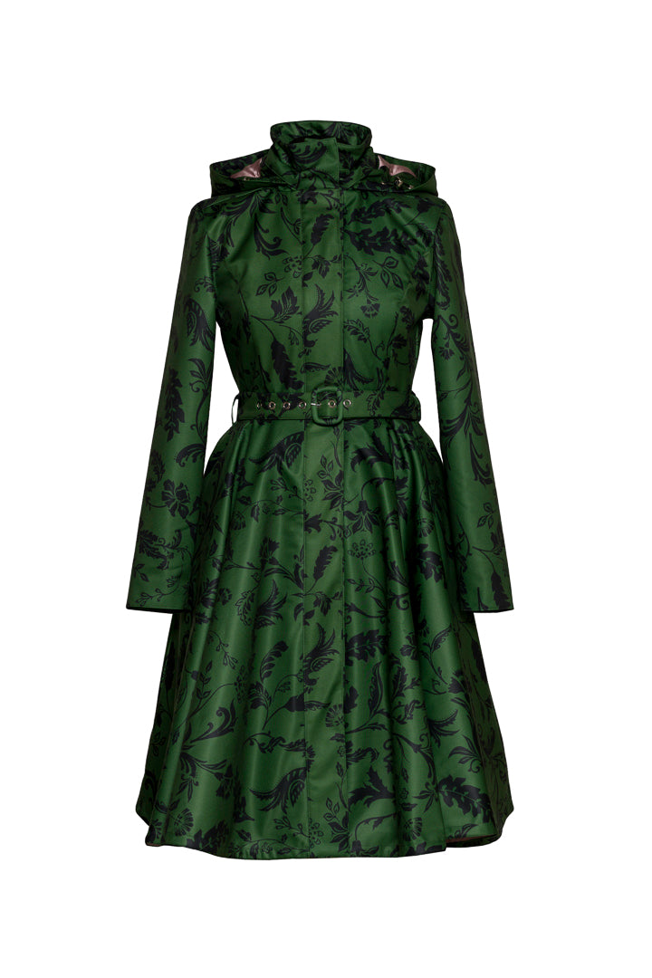 A green long-sleeve coat with a black floral pattern, featuring a high structured collar, a matching waist belt, and a flared skirt, shown against a plain white background.