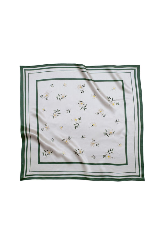 White square scarf with floral pattern and green border on a white background