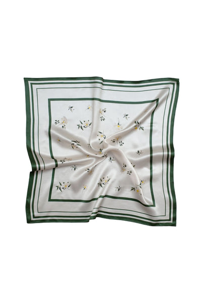 White square scarf with green border and floral patterns on a white background