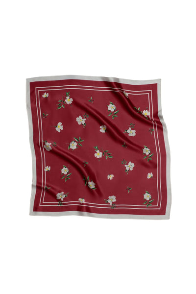 Red square scarf with floral pattern on a white background
