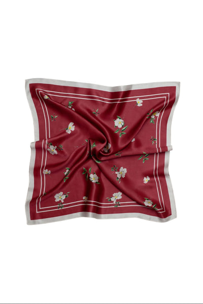 Red square scarf with floral patterns on a white background