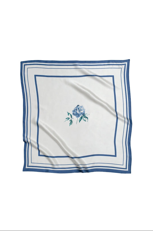 White square scarf with blue floral design and border on a white background
