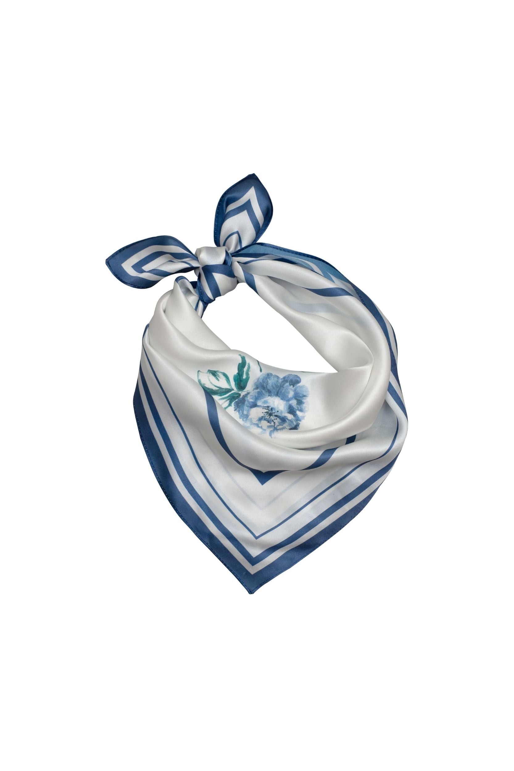 White scarf with blue floral design and stripes on a white background