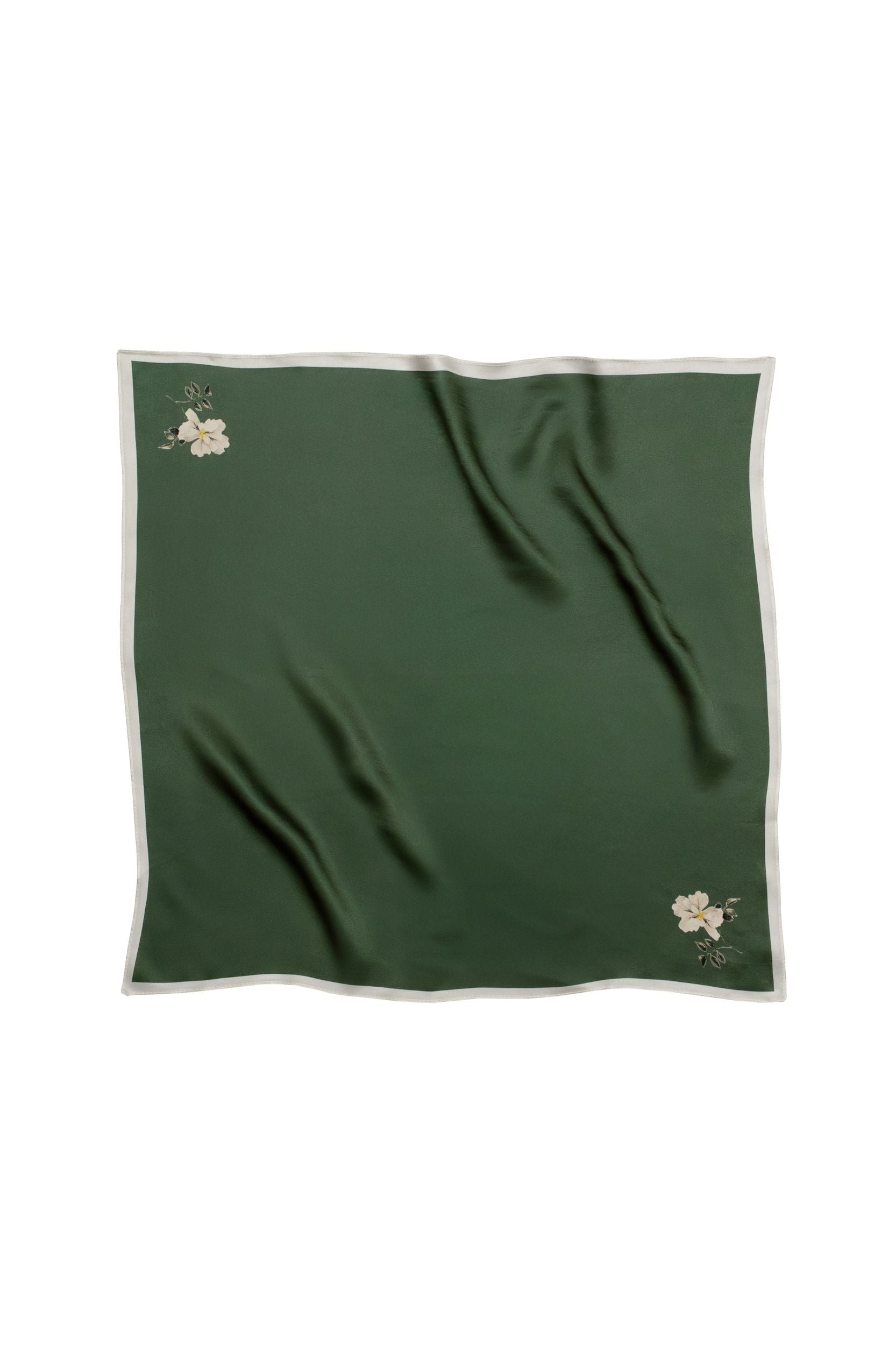 Green fabric with floral minimalistic print on a white background