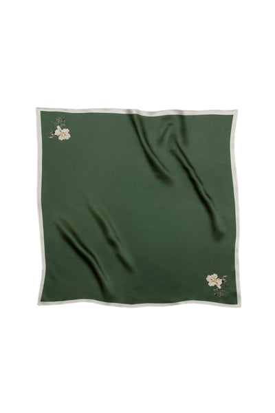 Green fabric with floral minimalistic print on a white background