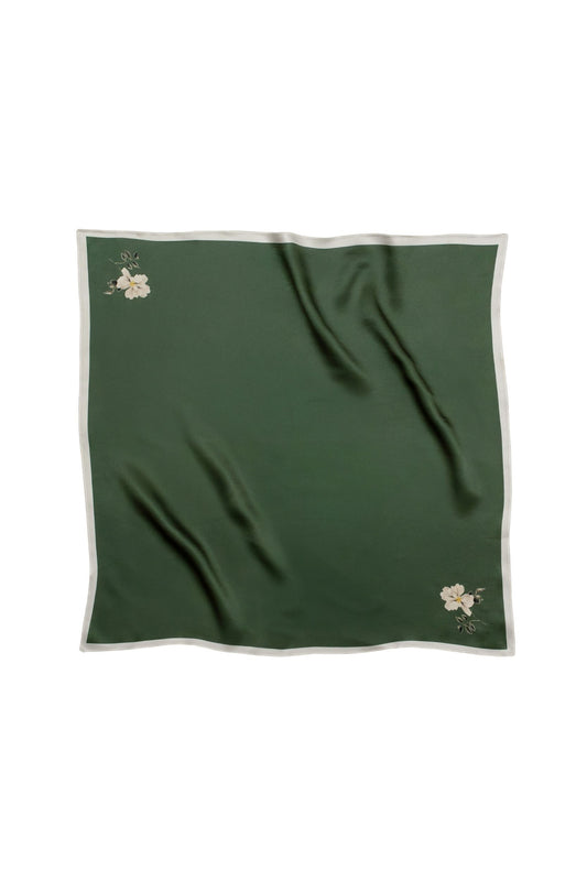 Green fabric with floral minimalistic print on a white background