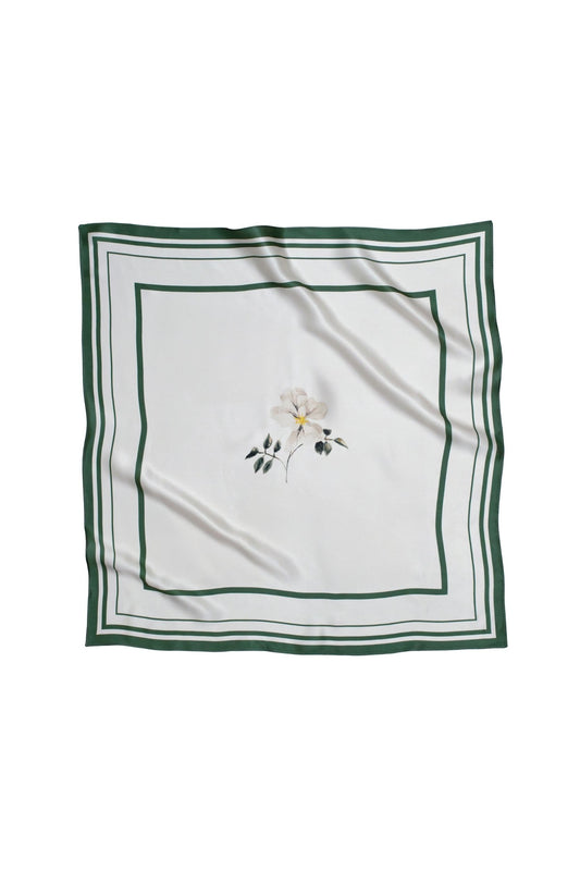 White square scarf with floral print and green border on a white background