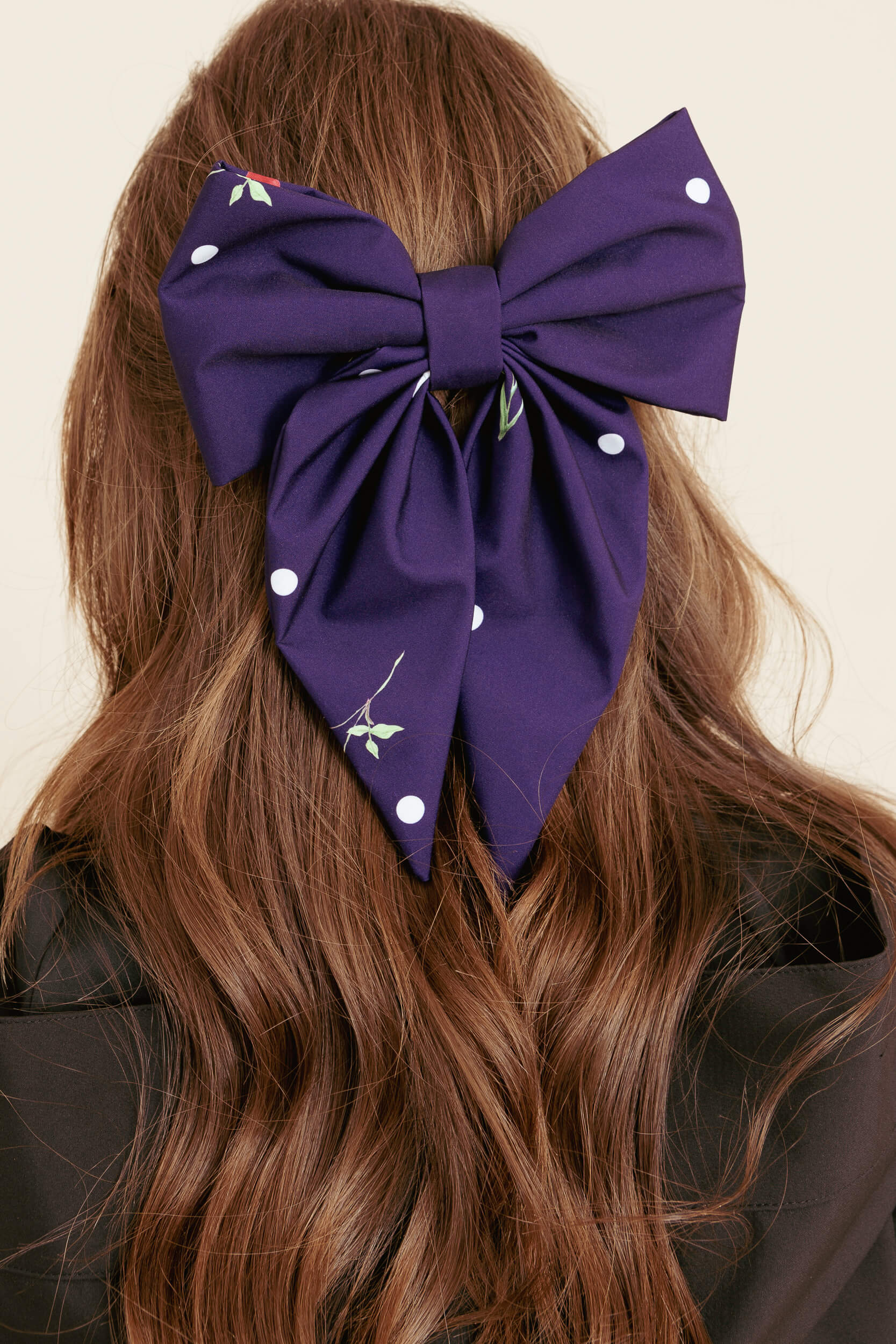 Violet oversize hair bow in brown hair