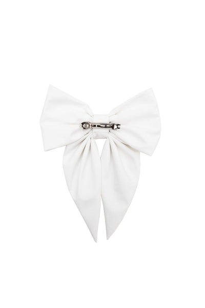 White bow-shaped hair accessory on a white background