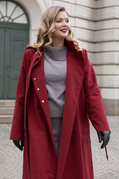 The double-breasted maroon coat by RainSisters flows gracefully, a luxury outerwear piece for the modern woman.