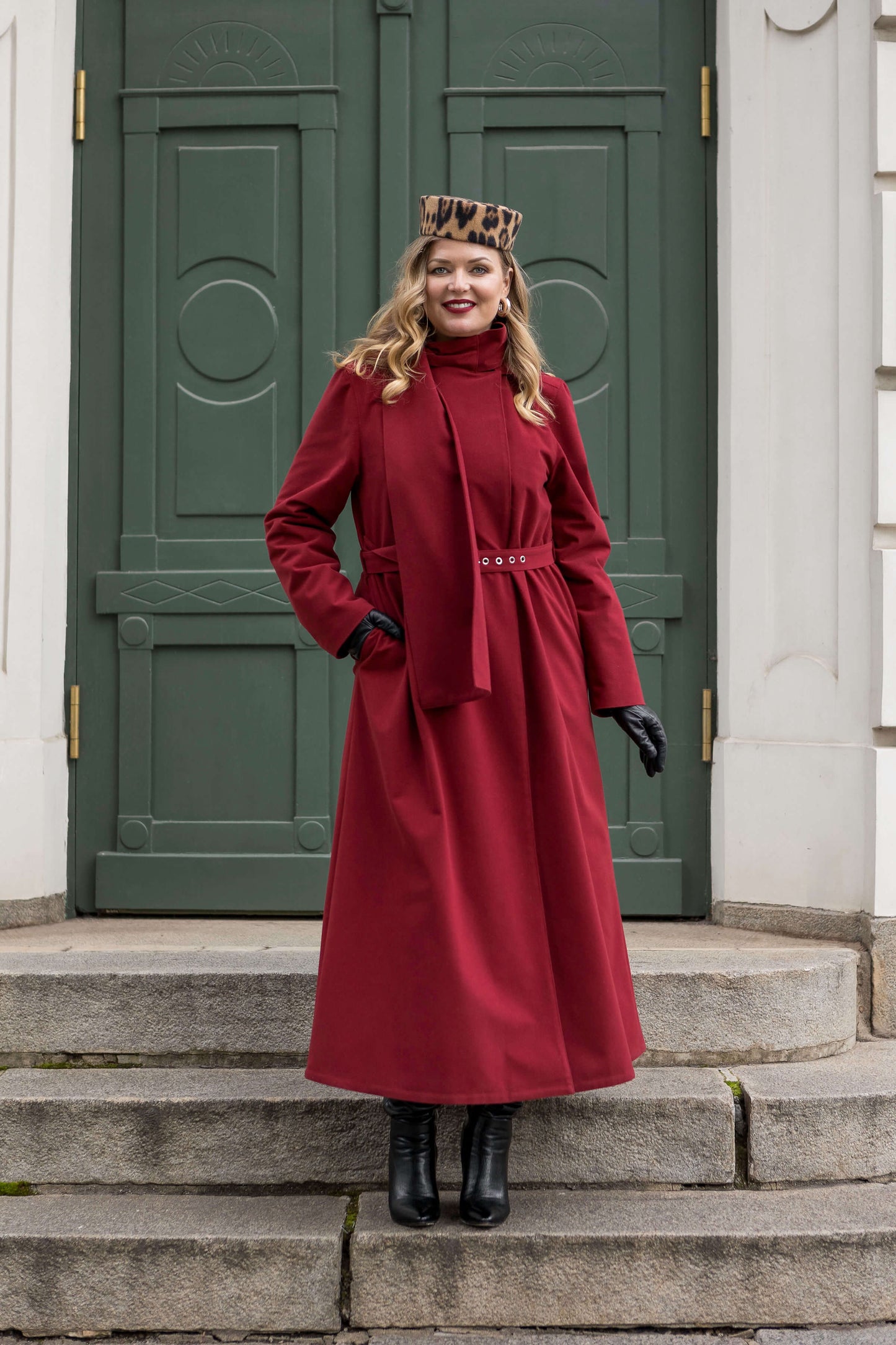 Woman wearing the Winter Maroon long coat by RainSisters — elegant, belted, and warm for cold winter days.