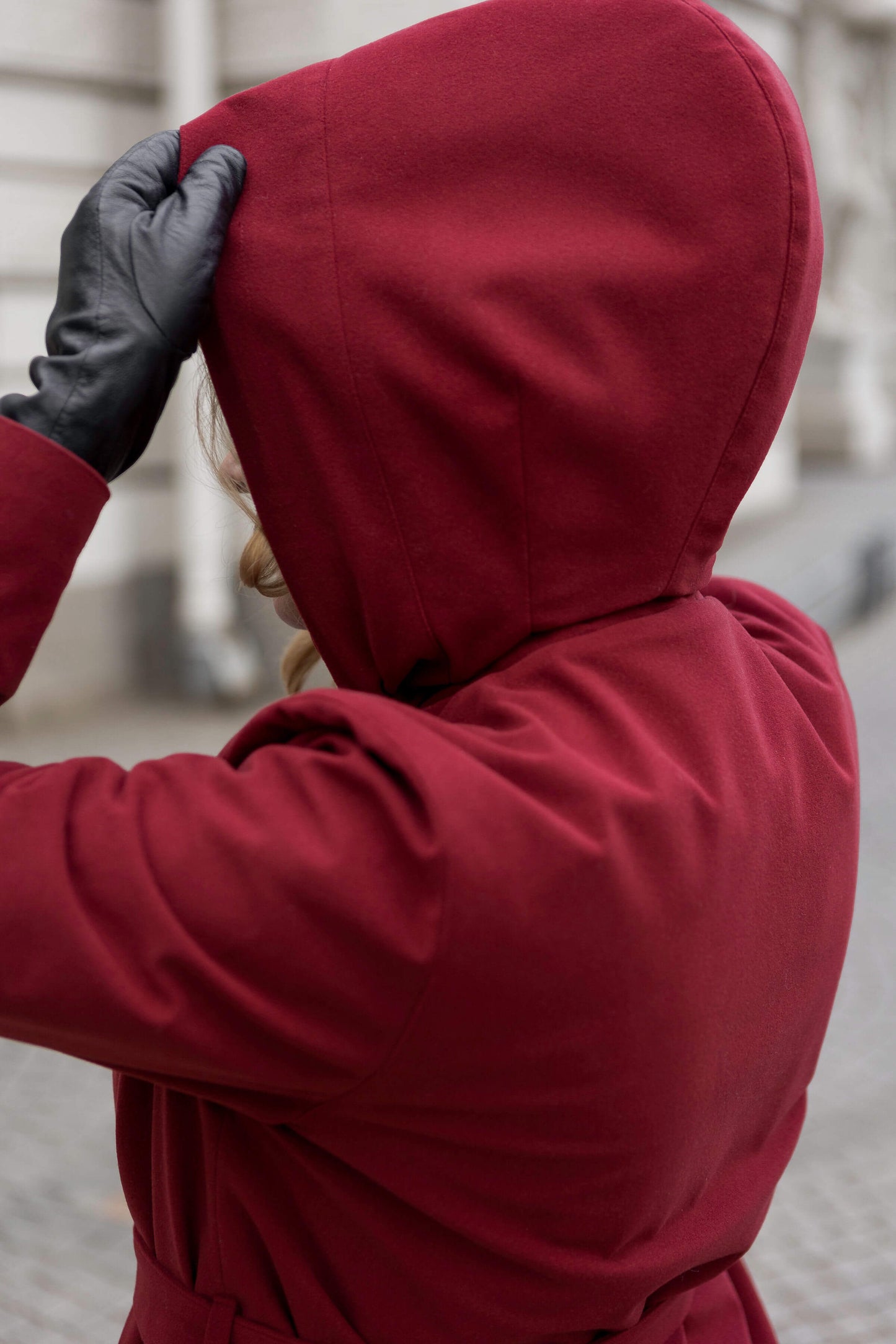 Model wearing the RainSisters Winter Maroon coat — luxury sustainable fashion for cold weather.