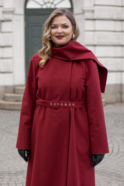 Full-length maroon winter coat with detachable hood — sustainable, waterproof, and beautifully feminine.
