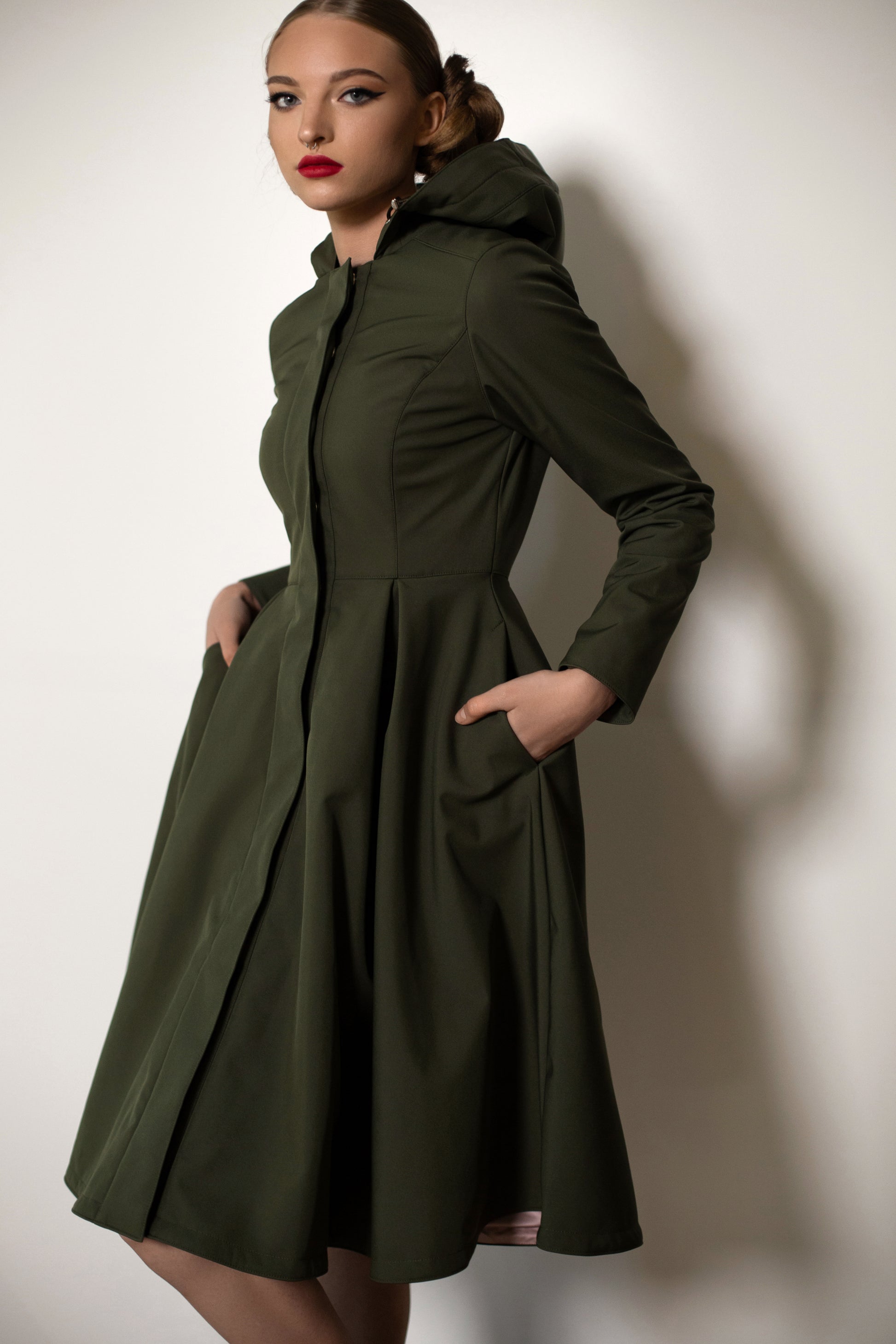 fitted and flared green women's coat with pleated skirt part