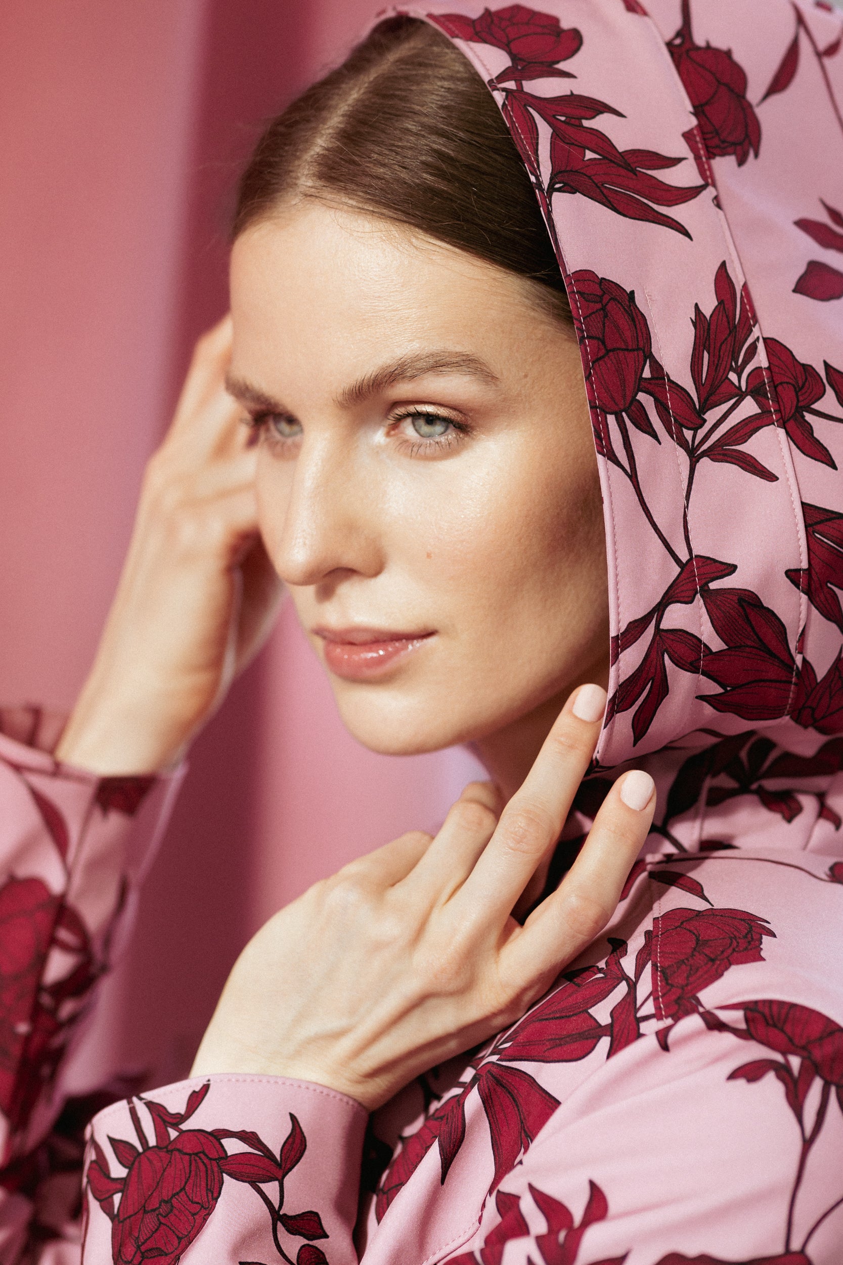 Close-up of the Peony Bloom coat’s burgundy peony print on soft pink fabric, highlighting the waterproof and breathable texture.