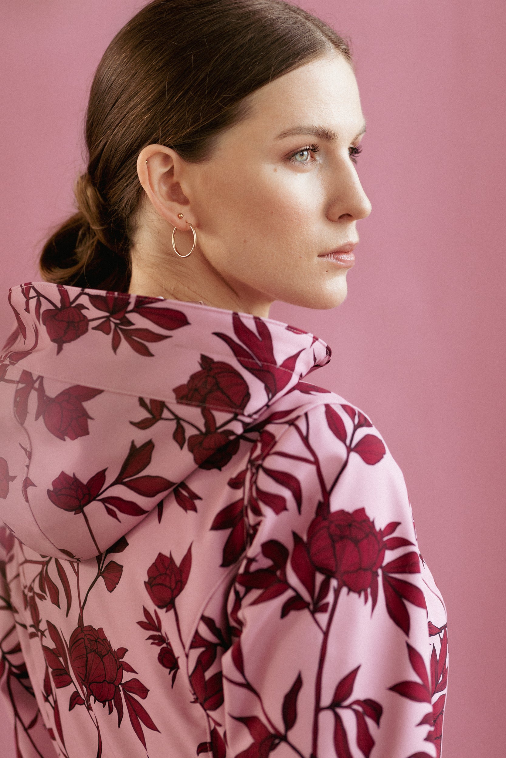 Close-up of the adjustable hood on the Peony Bloom coat in soft pink with burgundy peony print.
