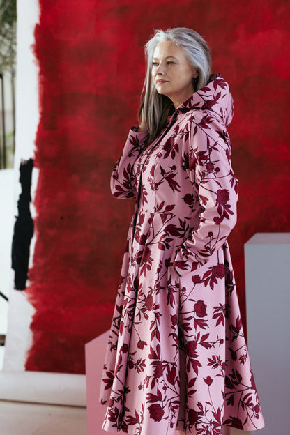 Model wearing the Peony Bloom coat with hands in the discreet side seam pockets, highlighting functionality and style.