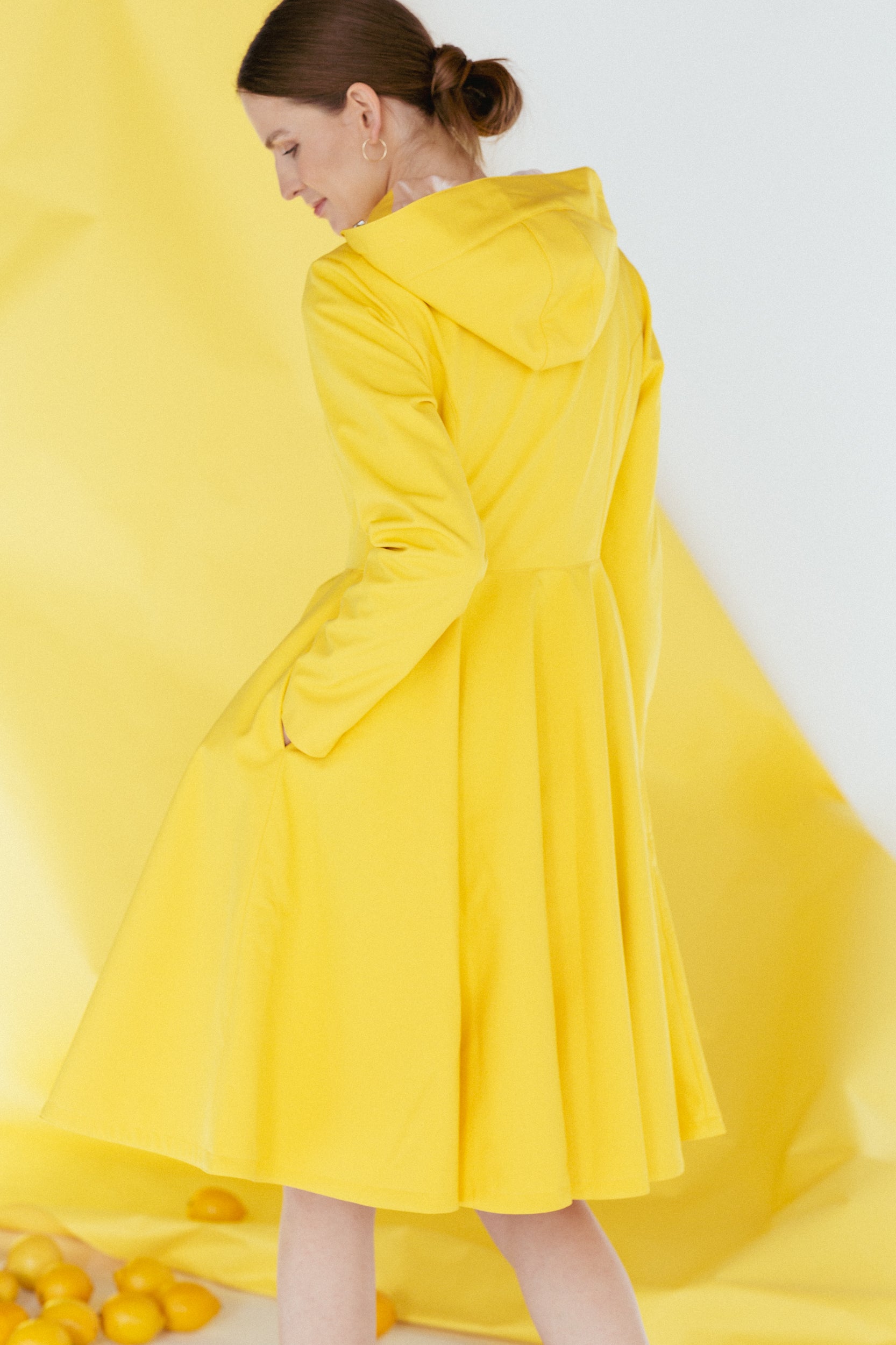 Back view of hooded Yellow Sun coat in bright yellow color and full circle skirt.