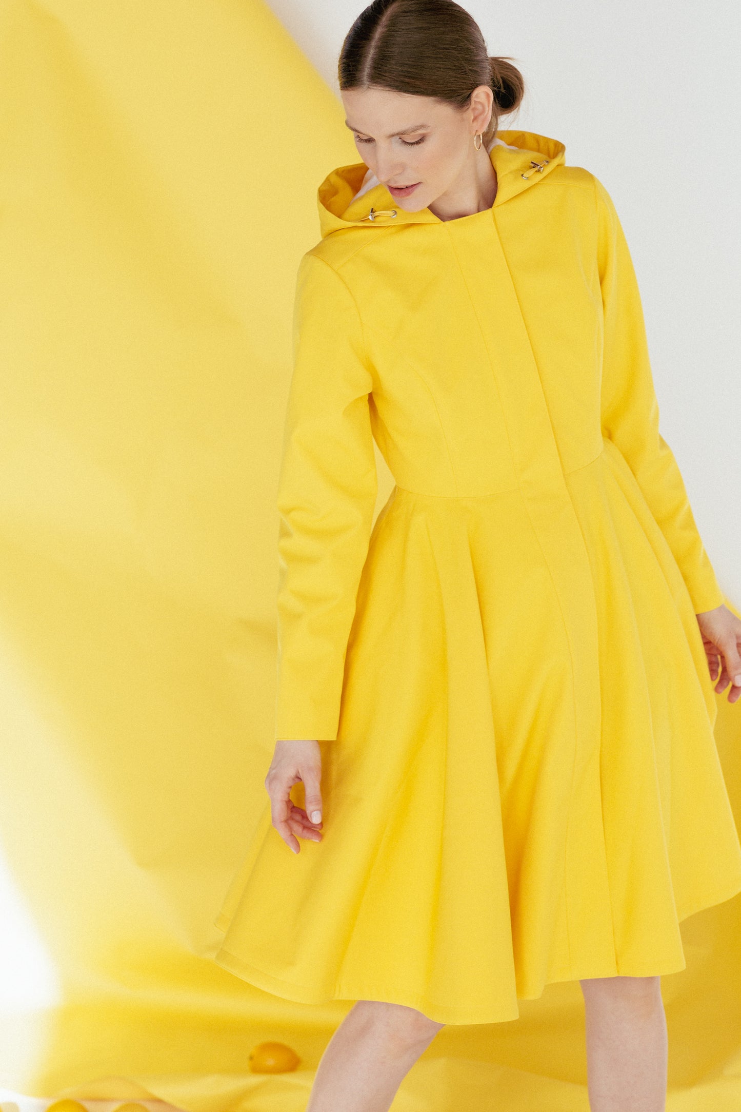 Model wearing Yellow Sun coat showcasing fit and flared design.